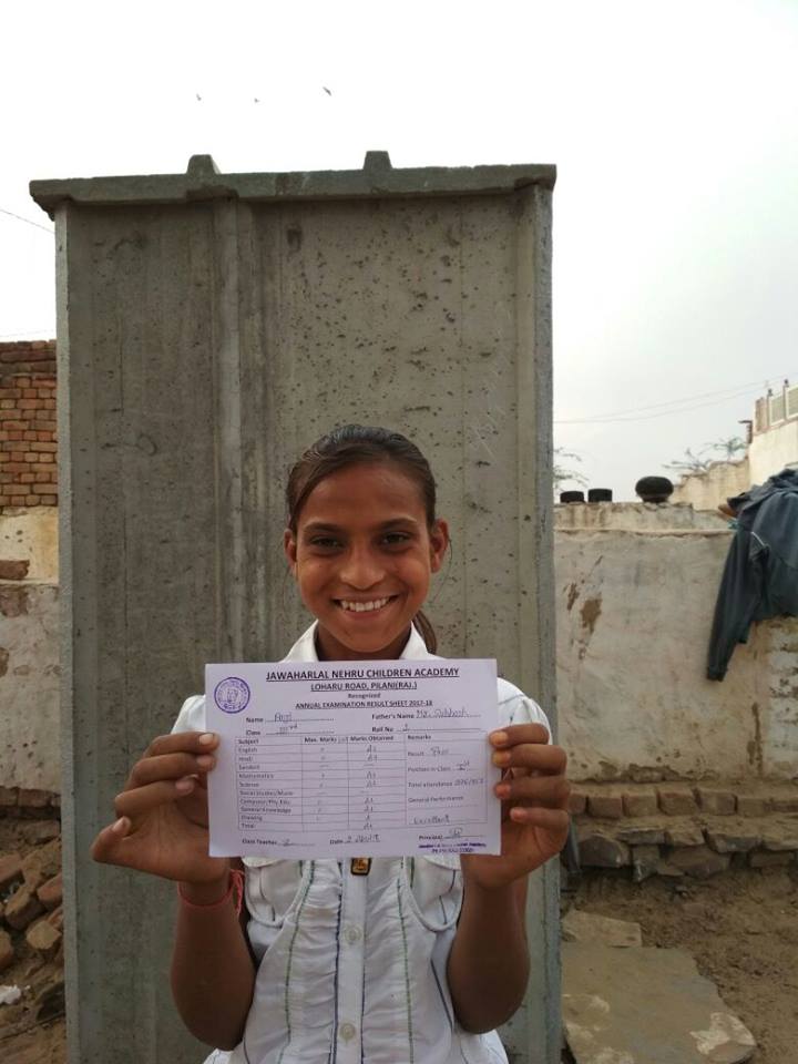 10-year-old Anji with her school certificate.