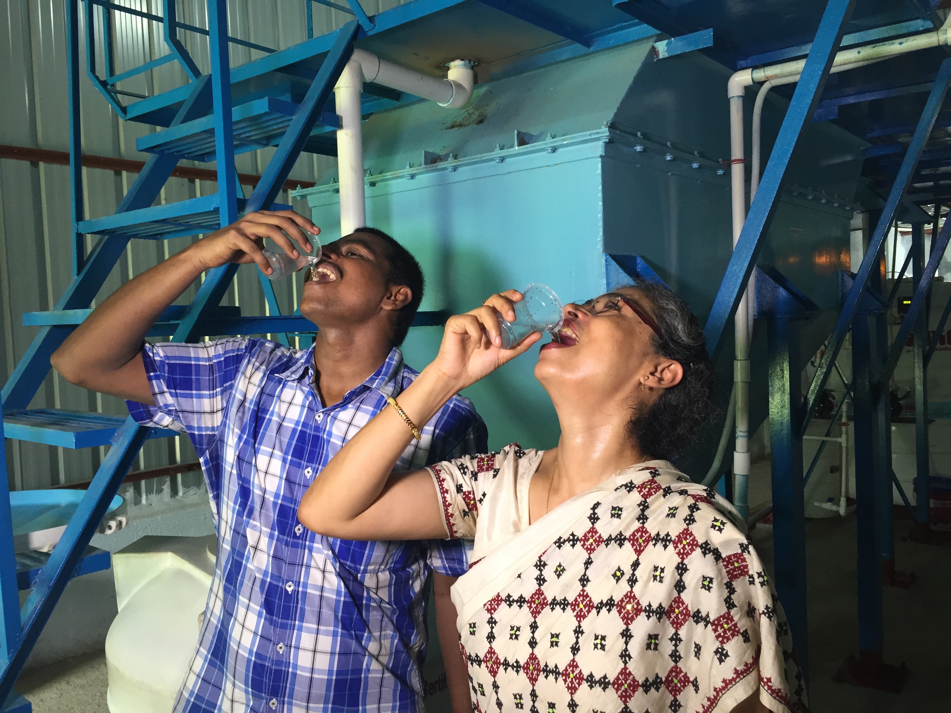 Professor Joyashree Roy and project member Sreeman Mypati tasting water from ECAR plant.