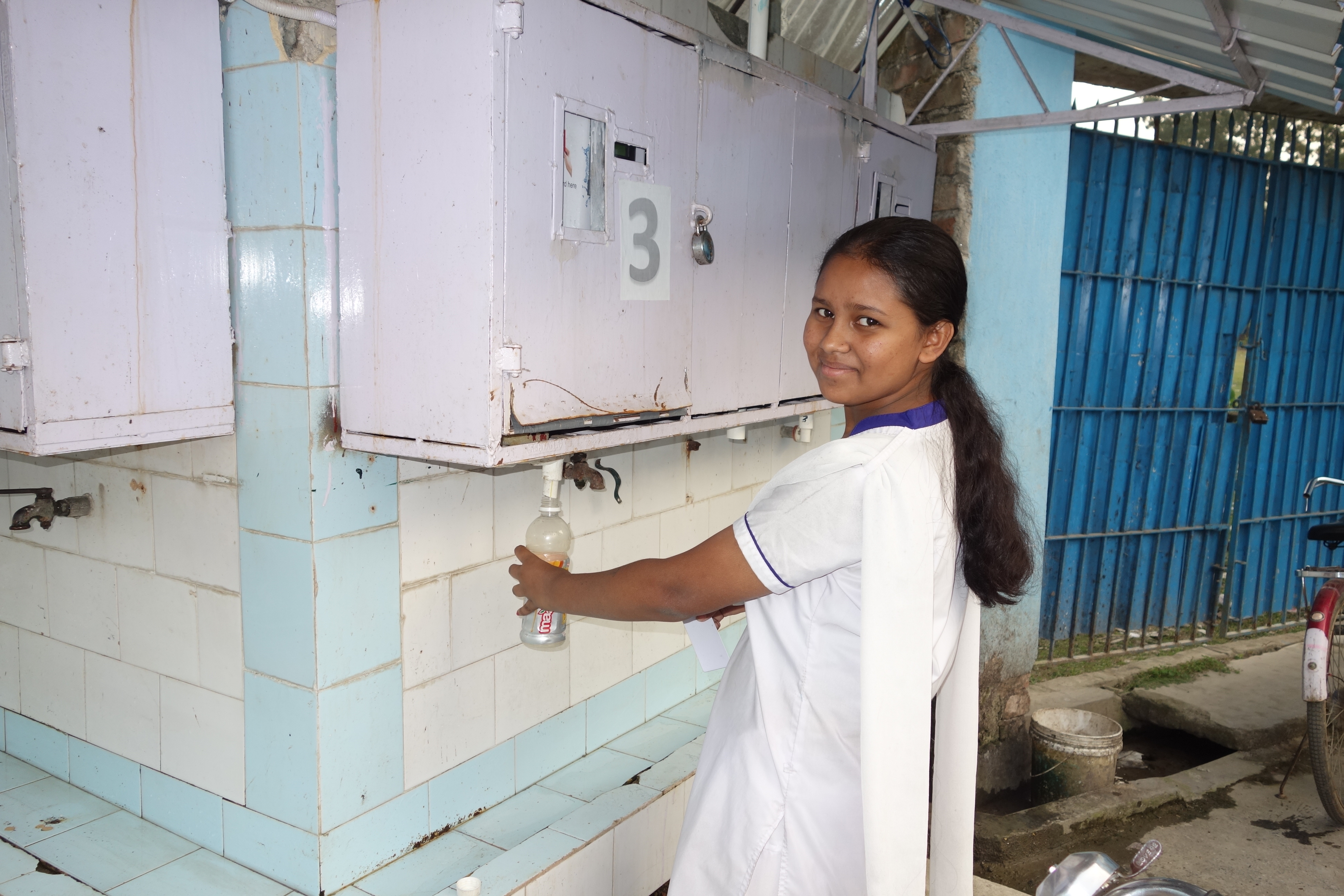 Students from Dhapdhapi High School taking arsenic free water using her electronic card.