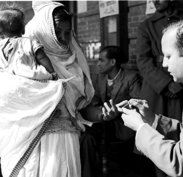First General Elections (Polling Day in Delhi January 14, 1952): A Polling Officers affixes indelible ink mark on the fore-finger of a voter before allowing her to cast the vote. (Source: Photodivision.gov.in)
