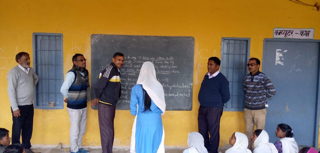 School monitoring visit: Officials on a random inspection.
